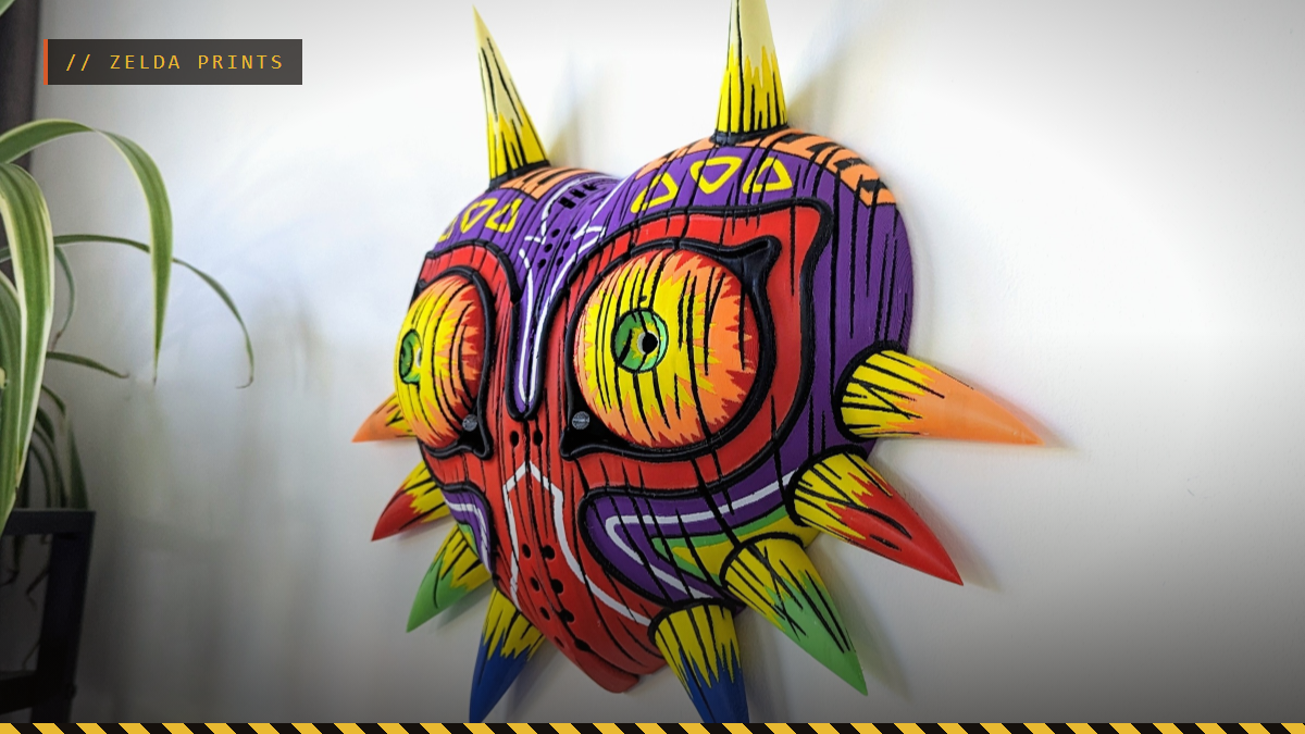 A multicolor 3D printed Majora's Mask hanging on a wall, by 3DPrintDogs