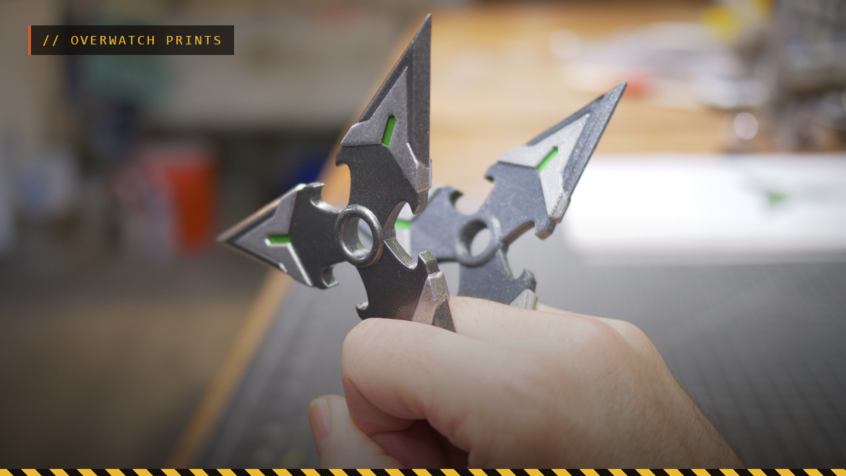 A hand holding a 3D printed Genji shuriken from Overwatch, by GizmoThrill
