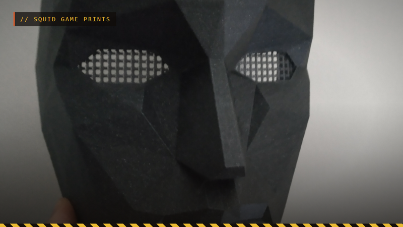 A close-up of a 3D printed Squid Game Front Man mask in black, by r1nce