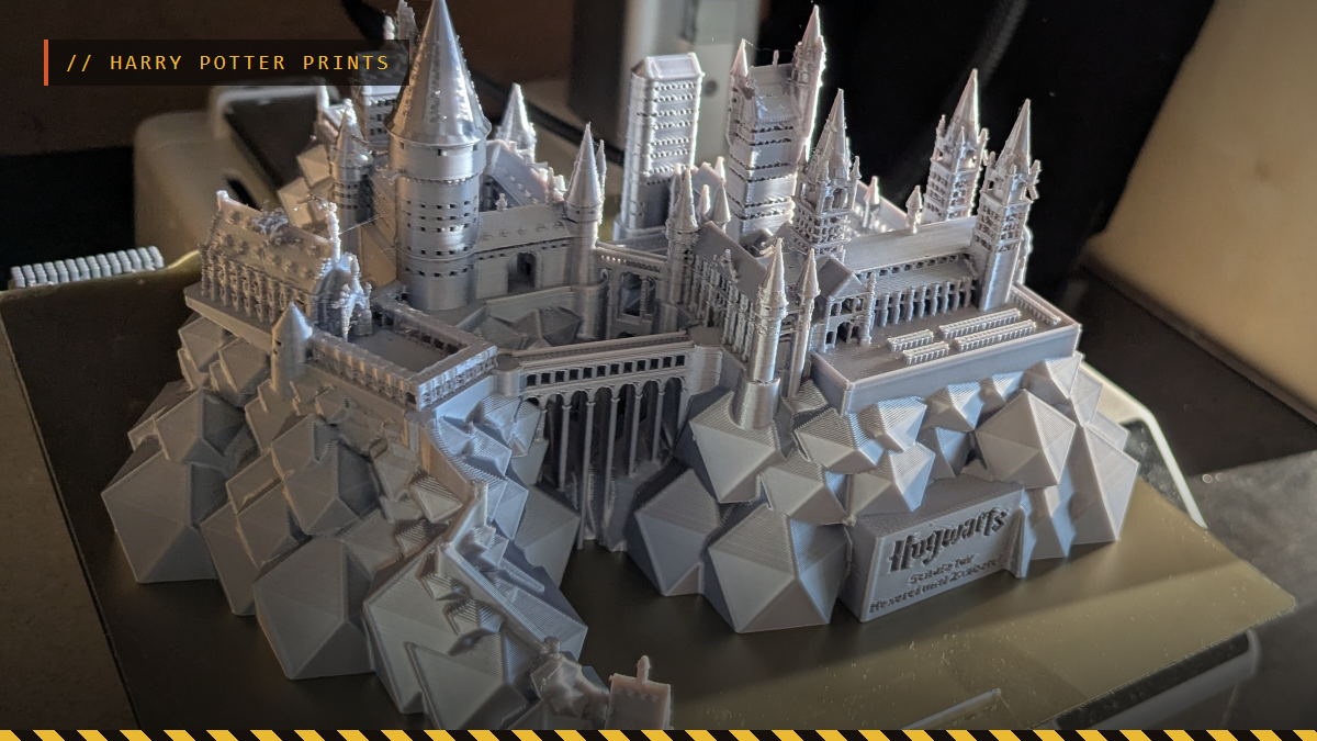 A 3D printed Hogwarts castle in gray on a printer bed, by Sebastian